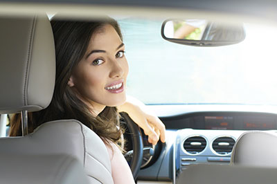 Woman looking back from driver's seat