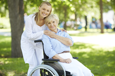 Helper and woman in wheelchair