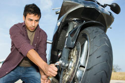 Man repairing motorcycle