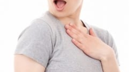 Woman with a short haircut looking back over her shoulder with a shocked and gasp facial expression