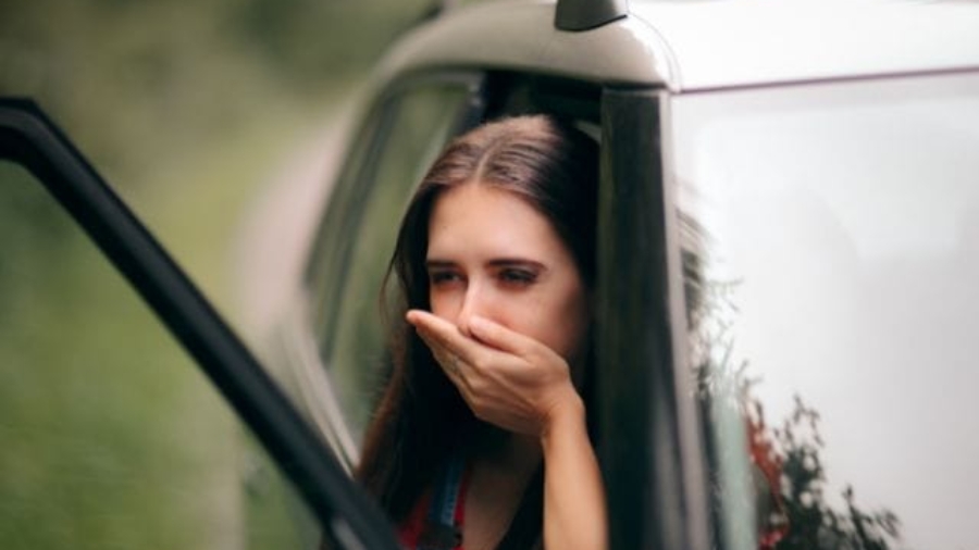 Woman with a short haircut looking back over her shoulder with a shocked and gasp facial expression