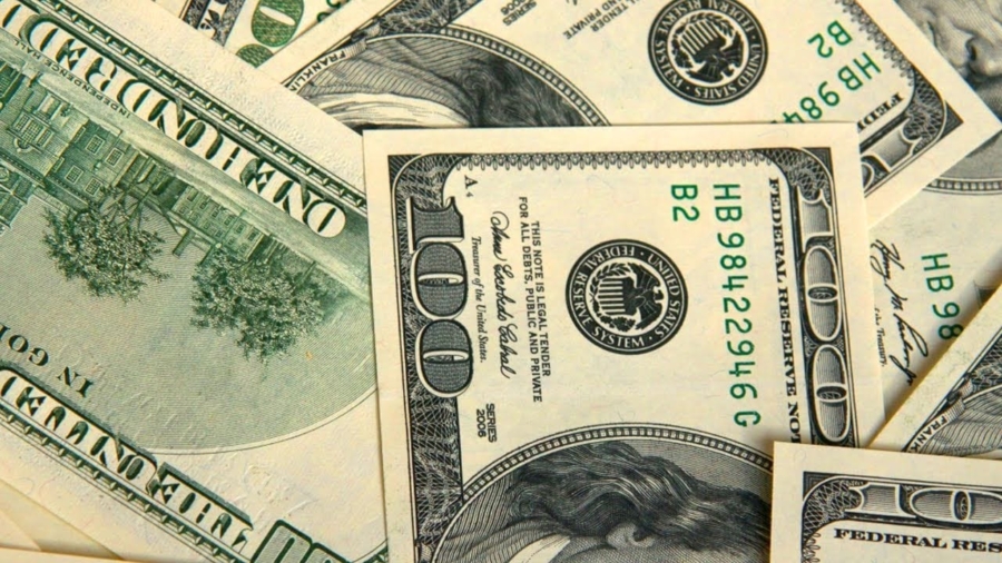 Fanned out one-hundred-dollar bills representing insurance claim deductibles and out-of-pocket costs