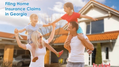 Smiling mother and father playfully carrying their two young daughters on their shoulders outside a suburban home