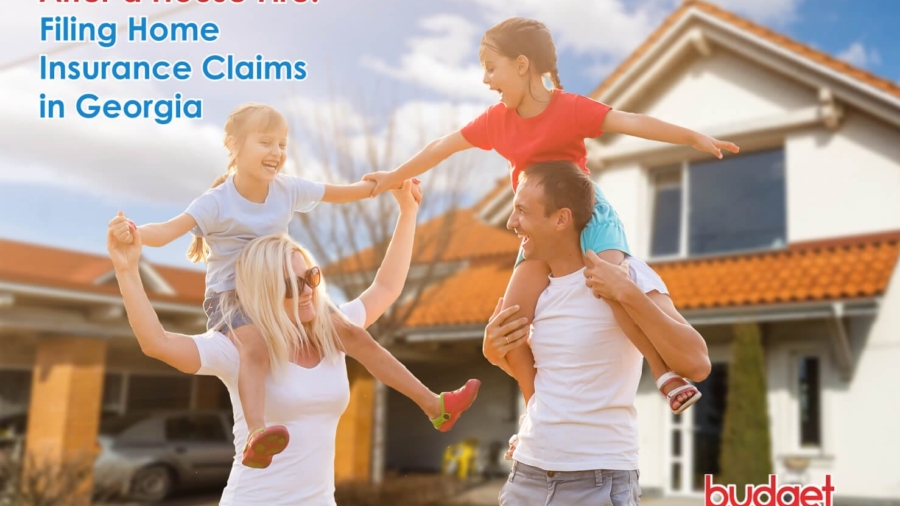 Smiling mother and father playfully carrying their two young daughters on their shoulders outside a suburban home