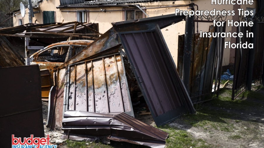 Severe storm and hurricane damage showing a collapsed fence, burnt vehicle, and structural property destruction