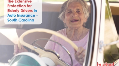 Smiling elderly woman behind the wheel of a classic vintage car