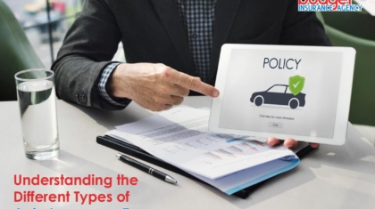 Insurance agent pointing at a digital tablet screen displaying an auto policy icon