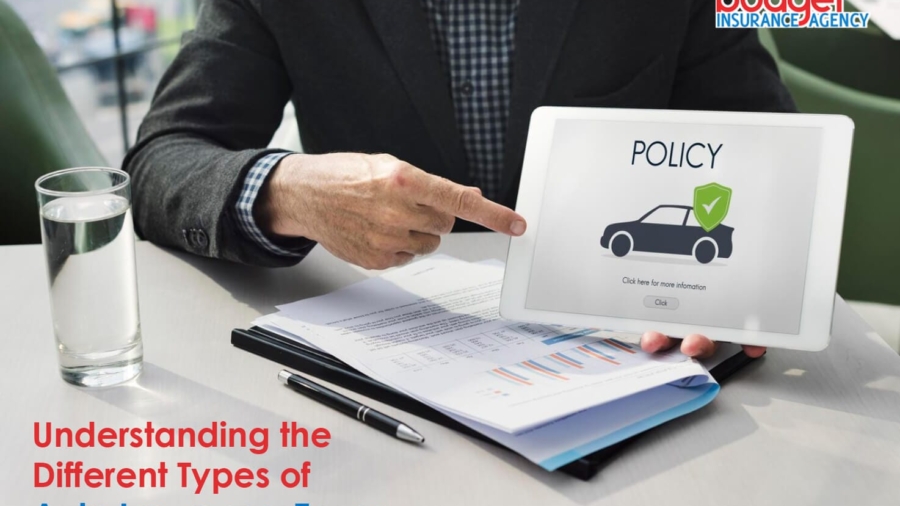 Insurance agent pointing at a digital tablet screen displaying an auto policy icon